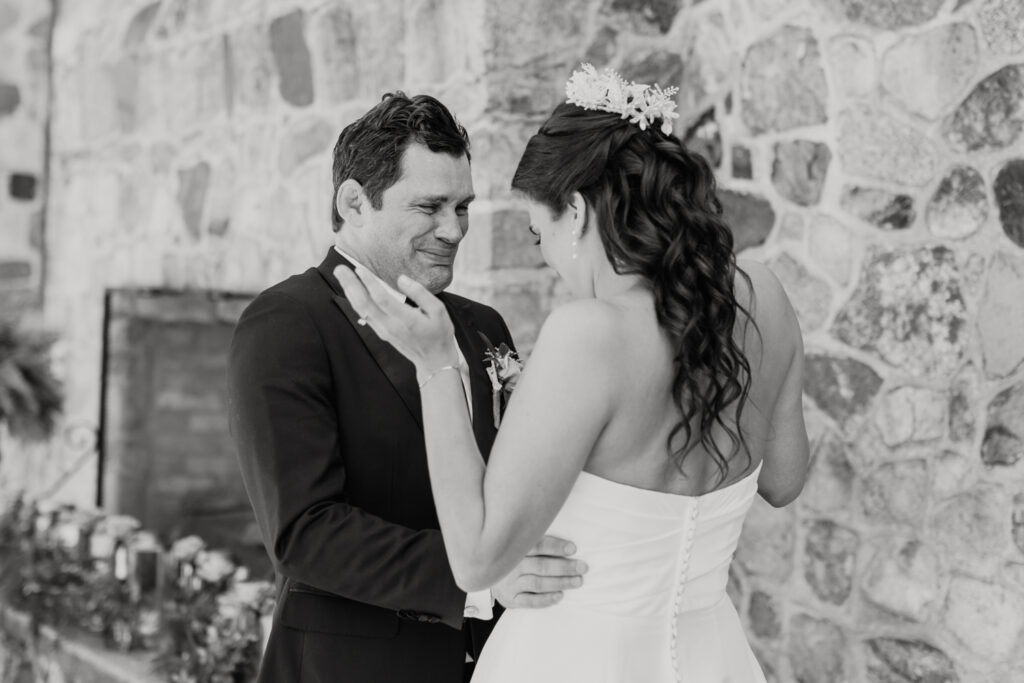 Bride with brown hair in a white strapless dress and crown seeing groom with brown hair in a navy suit for the first time at The Palmer Building Wedding Venue. Photographed by Charlotte Wedding photographer, Stephanie Bailey.