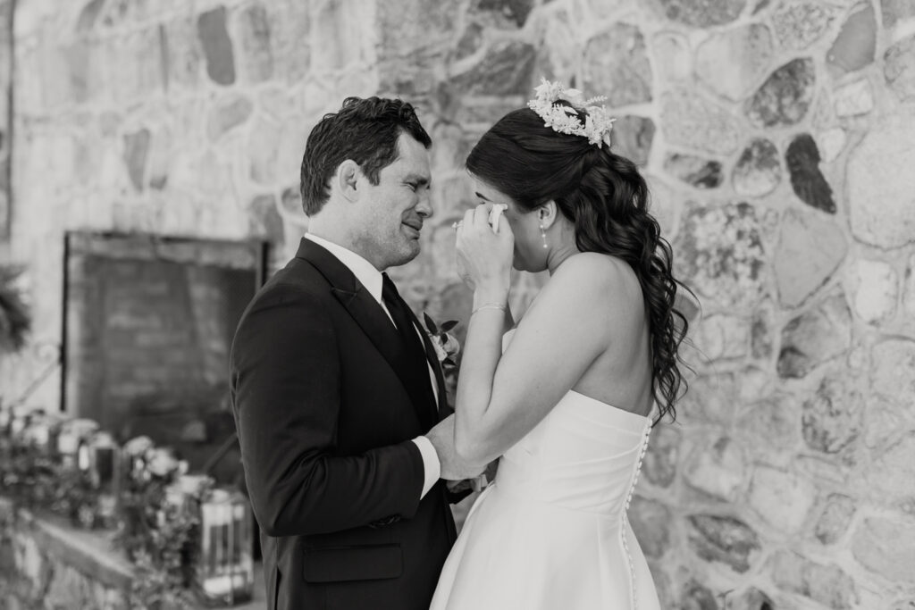 Bride with brown hair in a white strapless dress and crown seeing groom with brown hair in a navy suit for the first time at The Palmer Building Wedding Venue. Photographed by Charlotte Wedding photographer, Stephanie Bailey.